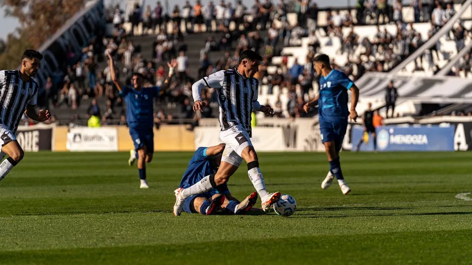 Action-packed soccer game with athletes competing intensely outdoors during the day.