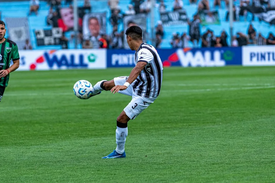 Dynamic shot of a soccer match with players in action on a grassy field.