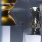 An elegant trophy displayed inside a glass case, showcasing achievement and excellence.